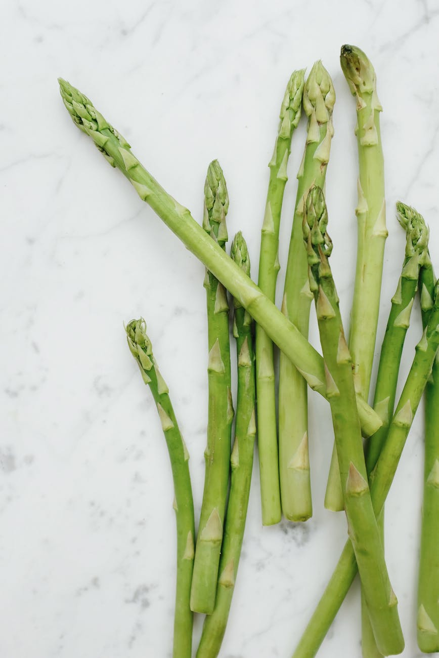 green asparagus on marble table