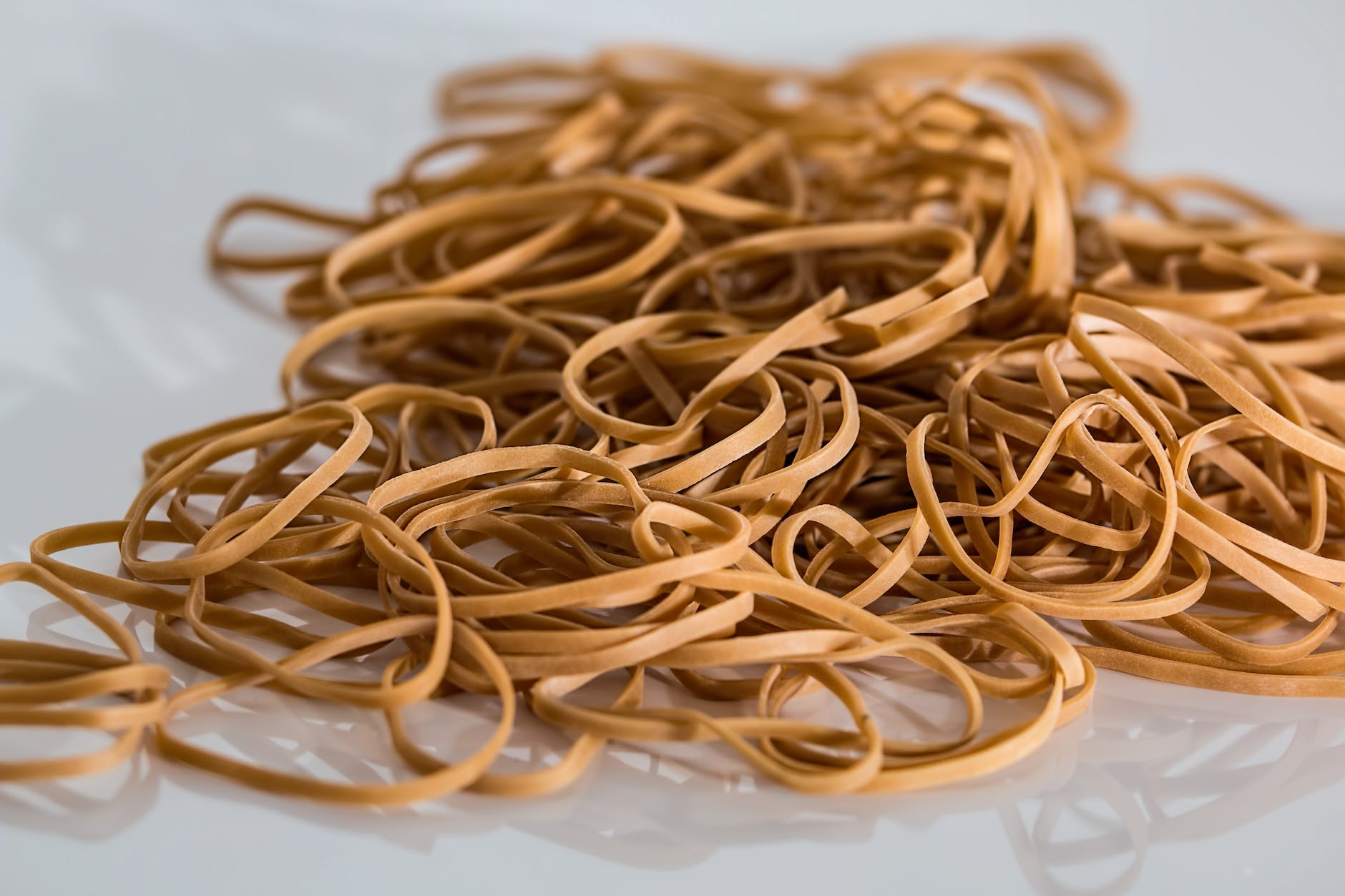 How can you prevent your cat from swallowing a rubber band or hair tie?