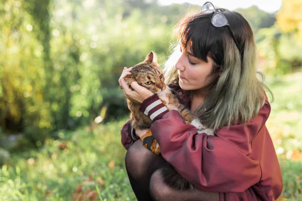 a girl and a cat on the outside