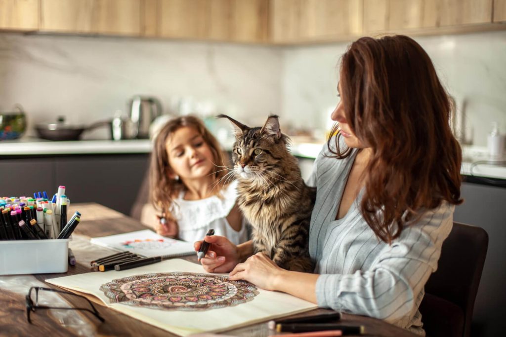 a cat with family on the kitchen table